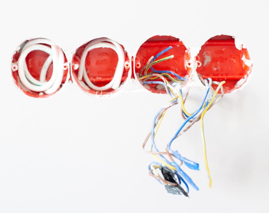 Καλώδια προεξέχουν από λευκό τοίχο