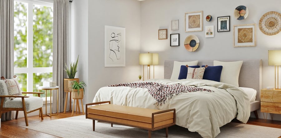 Κρεβατοκάμαρα με πολλά κάδρα στον τοίχο και ντιβάνι μπροστά σε κρεβάτι