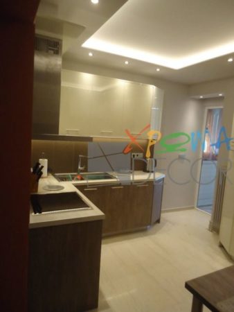 Μοντέρνα κουζίνα σε ανακαίνιση στα Κάτω Πετράλωνα με λευκό πάγκο και κρυφό φωτισμό οροφής