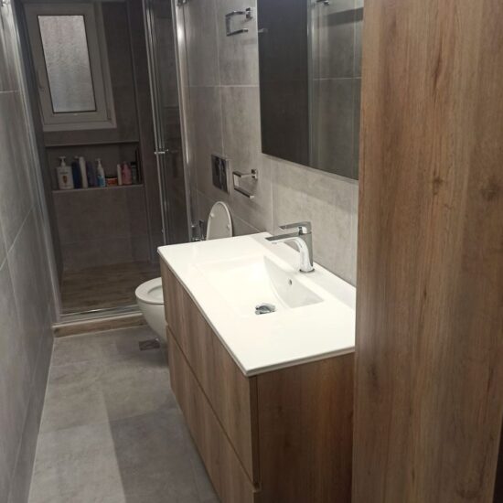 Ανακαίνιση μπάνιου στη Νίκαια με μοντέρνο έπιπλο νιπτήρα και γκρι πλακάκια