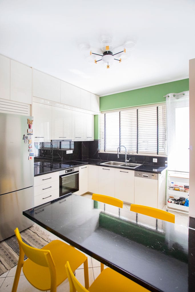 Ανακαινισμένη κουζίνα με τραπέζι και μοντέρνα ντουλάπια σε διαμέρισμα στον Πειραιά